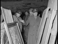 Gen. Dwight D. Eisenhower, Supreme Allied Commander, accompanied by Gen. Omar N. Bradley, left, CG, 12th Army Group, and Lt. George S. Patton, Jr., CG, US Third Army, inspects art treasures stolen by Germans and hidden in a salt mine in Germany.